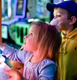 kids playing bright arcade games
