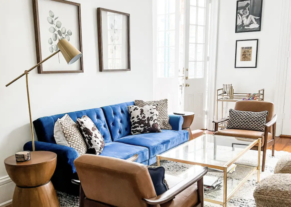 living room with blue couch and iron-accented decor
