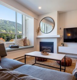 Living room with a fireplace, flat screen TV and the mountain view