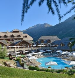 View of a mountain resort with a swimming pool