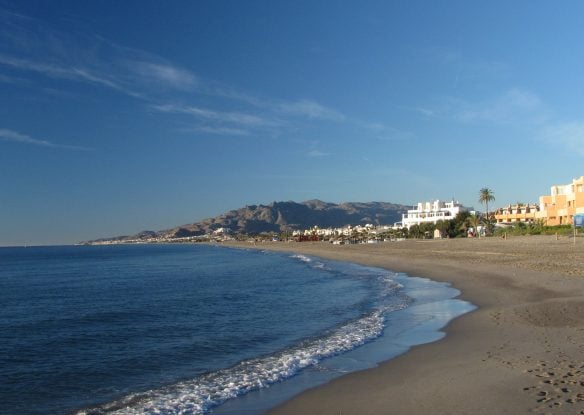 View of a sandy beach with mountains in the distance