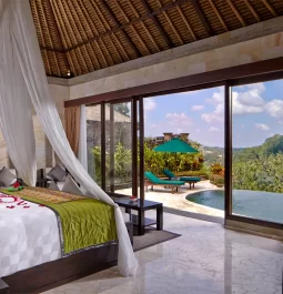 luxury hotel room with private pool and mosquito net around bed
