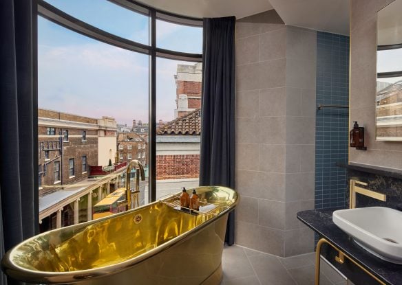 Golden bathtub overlooking city