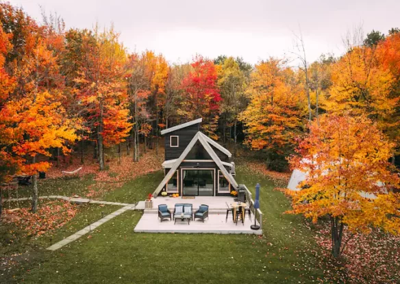A-frame cabin with fall trees