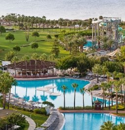 Aerial view of a resort with swimming pools and a water park