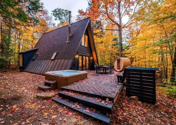 beautiful A-frame cabin and hot tub surrounded by brilliant fall foliage