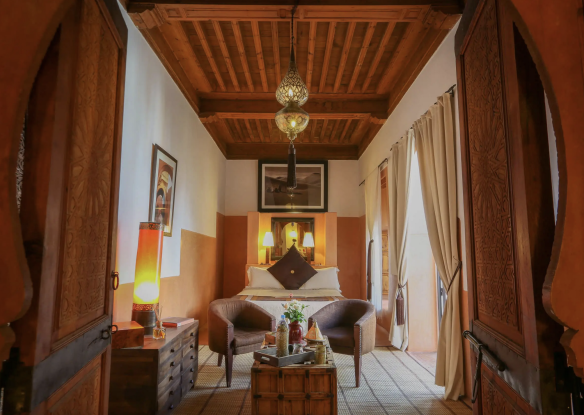 interior of hotel room with wood panel ceiling and moroccan lanterns